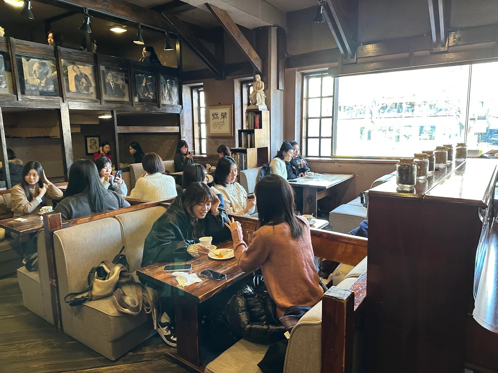 Customers sit in the wood-paneled interior of Hakrim Dabang in Seoul.