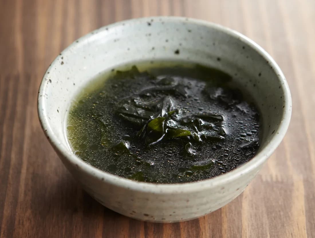 A ceramic bowl filled with miyeok-guk, Korean seaweed soup